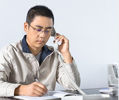 a man is on the phone, offering customer service to clients
